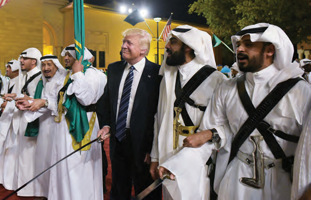 U.S. President Donald Trump joins a traditional sword dance at a welcome ceremony ahead of a banquet at the Murabba Palace in Riyadh on May 20, 2017.  AFP PHOTO /  MANDEL NGAN