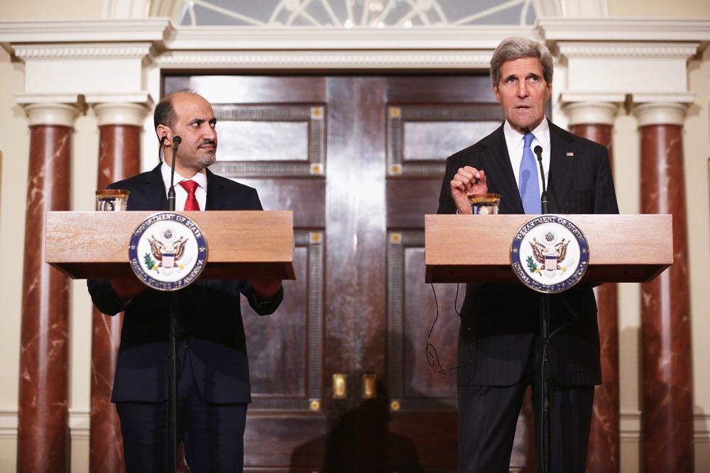 U.S. Secretary of State John Kerry speaks as Syrian Opposition Coalition President Ahmad al-Jarba listens as they make remarks to the media May 8, 2014 at the State Department in Washington, DC. Secretary Kerry had a meeting with President al-Jarba to discuss the current situation in Syrian. Getty Images / AFP / ALEX WONG