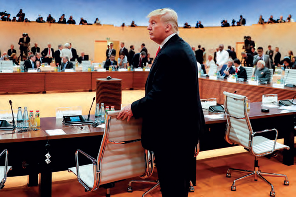 U.S. President Donald Trump standing alone during one of the working sessions of the G20 summit in Hamburg on July 8, 2017. AFP PHOTO / POOL / MARKUS SCHREIBER