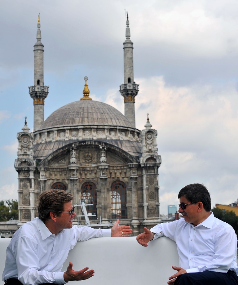 Guido Westerwelle and Ahmet Davutoğlu, then Foreign Ministers of Germany and Turkey respectively, chat in front of the Grand Mecidiye Mosque during their boat trip in Istanbul, on July 28, 2010.  AFP PHOTO / KERİM ÖKTEN