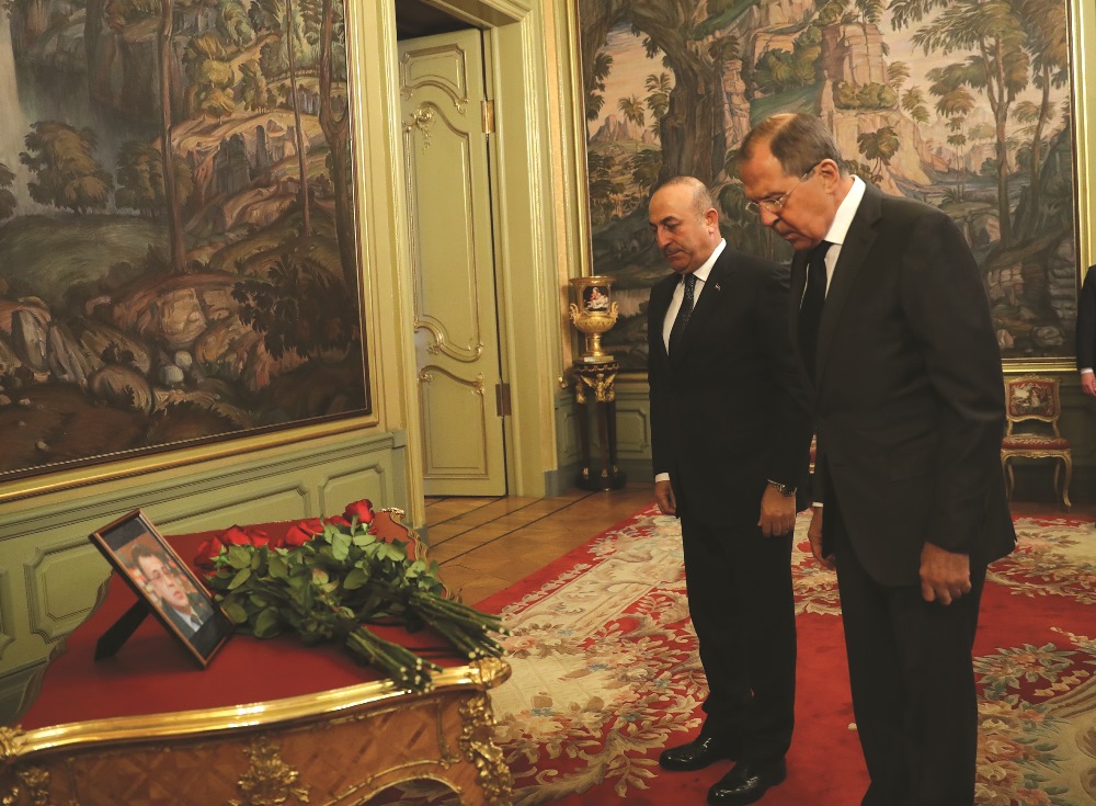 Foreign Minister of Turkey Çavuşoğlu and Russia’s Foreign Minister Lavrov lay flowers at a portrait of the murdered Russian Ambassador to Turkey, Andrei Karlov, in Moscow on December 20, 2016. | AA PHOTO / FATİH AKTAŞ