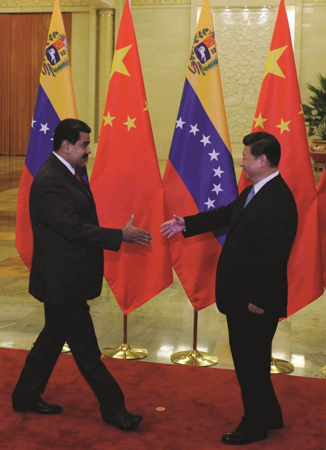 Chinese President Xi Jinping meets with Venezuela’s President Nicolas Maduro upon his arrival to Beijing before China’s huge military parade in September 2015.  AFP PHOTO / PARKER SONG
