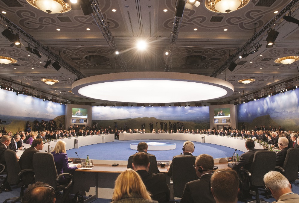 NATO attendees hold a meeting on the second day of the NATO 2014 Summit, on September 5, 2014. NATO leaders are expected to announce a raft of fresh sanctions against Russia on Friday over its actions in Ukraine, although hopes remain that a ceasefire can be forged at peace talks in Minsk on the same day.  AFP / Saul Loeb