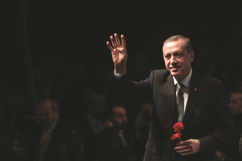 Prime Minister Erdoğan addressed the Union of European Turkish Democrats (UETD), showing Rabia  sign. AA